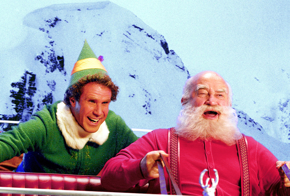 A man dressed as an elf, with a man dressed as Santa - an image from the Elf movie