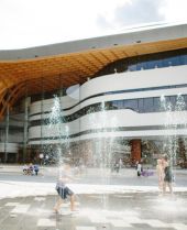 Children play in the water fountains outside Bunjil Place