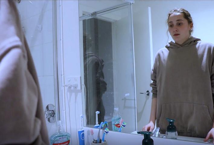 A person looking into a mirror