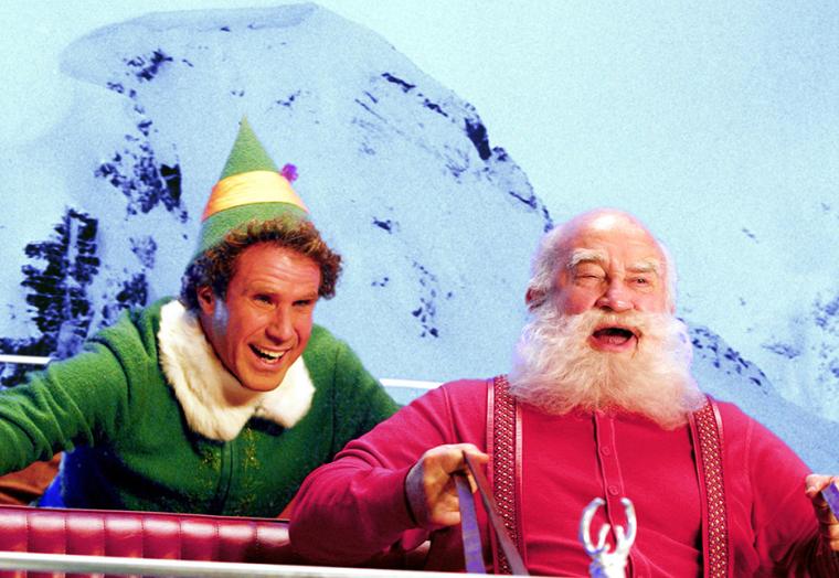 A man dressed as an elf, with a man dressed as Santa - an image from the Elf movie