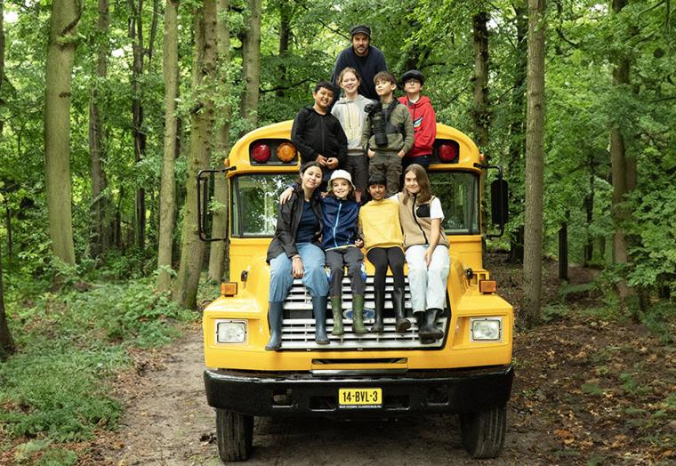 A group of young children in the back of a yellow bus