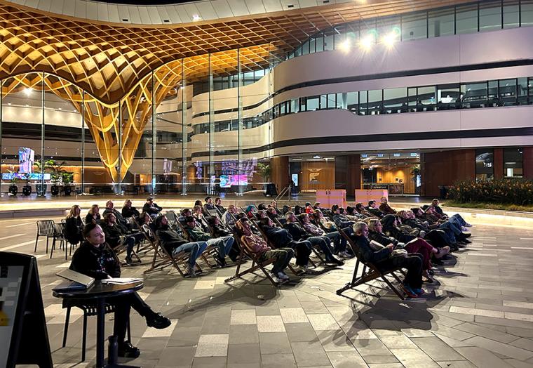 People sitting in an outdoor theatre for the Emergent Film Screening 