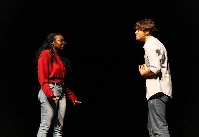 Two young actors performing on stage 