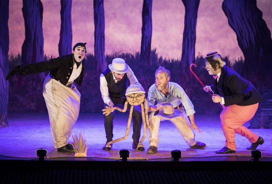 Four men on stage with a puppet - a scene from The Magic Pudding - The Opera