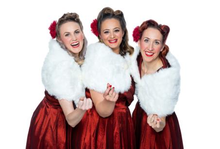 Three women in red dresses and white shawls - An Andrews Sisters Tribute